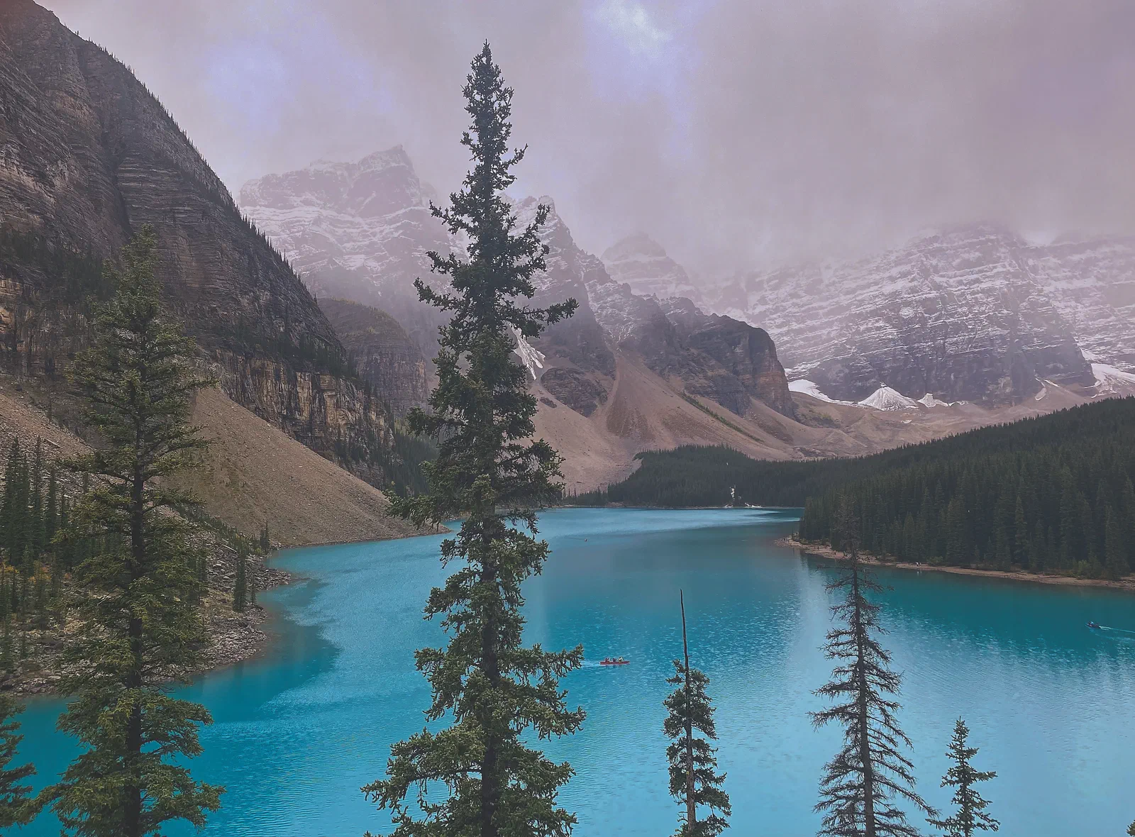 Moraine Lake, turquoise water below snow-dusted peaks and pines